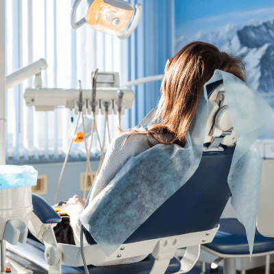 Woman sitting in dentist chair, dealing with dental anxiety