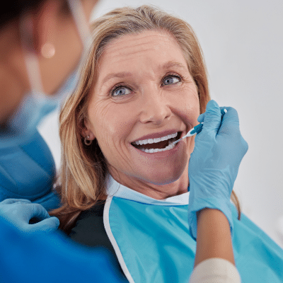 How adults can improve dental health 6 Older woman at her dental care appointment, representing how adults can improve dental health
