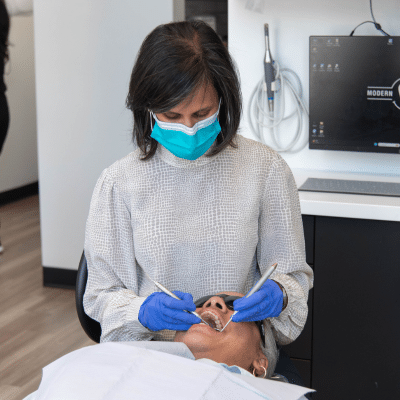 How a smile makeover improves confidence 4 Dr. Rita shah working on a patients teeth, representing how a smile makeover improves confidence
